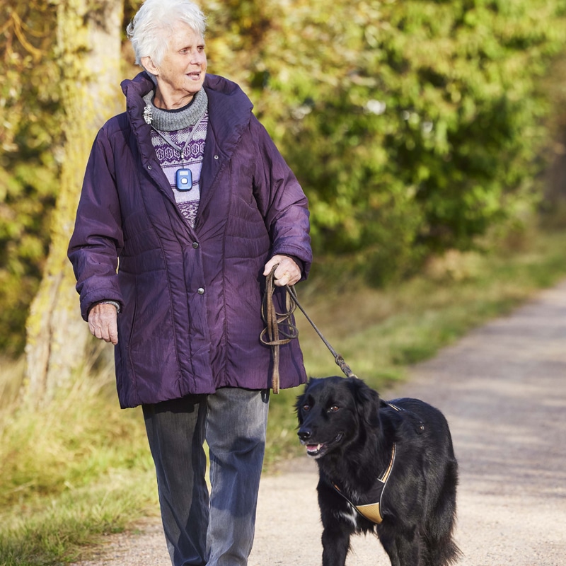 Lady walking her dog with an out-and-about personal alarm